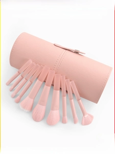 Close-up of 10-piece peach makeup brush set with pink leather storage case on white background