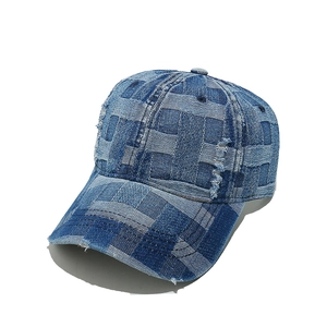 Macro detail of checkerboard denim fabric with distressed holes and frayed edge on baseball cap