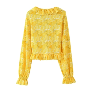 Detailed back view of yellow floral blouse with ruffle trim and pleated texture fabric