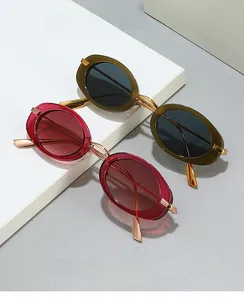 Detailed close-up of retro oval sunglasses with olive green and wine red frames