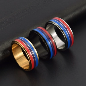 Modern spinning stainless steel rings in gold, black and silver with colorful enamel stripes