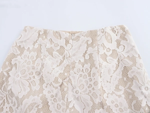 Close-up of white floral lace skirt featuring a hidden zipper and beige lining detail
