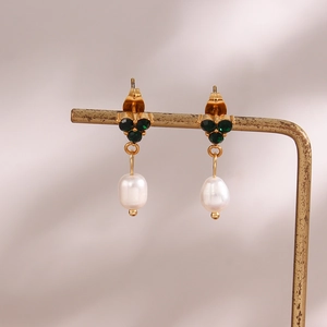 Detail of 18K gold earrings featuring three green crystals and a white freshwater pearl