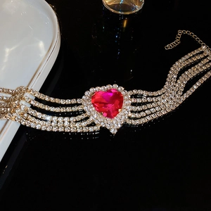Detail view of gold choker necklace with large pink heart crystal and crystal rows