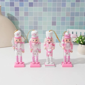 Detailed view of four pink and white wooden nutcracker soldier ornaments with glitter