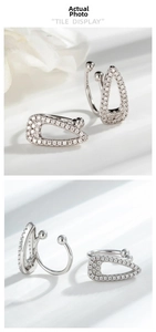 Detailed macro view of silver geometric triangle ear cuffs with micro-pave cubic zirconia