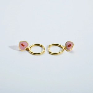 Macro shot of S925 sterling silver hoop earrings with pink enamel heart-shaped charms