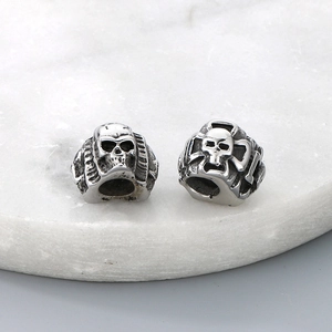 Macro shot of silver titanium steel skull beads with detailed metal textures