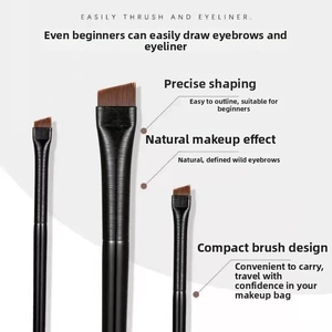 Detail view of professional angled eyeliner and brow brushes with synthetic brown bristles
