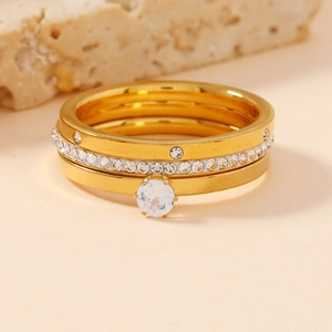 Three-piece gold stainless steel ring set with luxury crystal embellishments on rocks