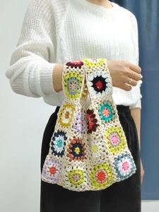 Detail of colorful granny square crochet tote bag showing hand-knitted patchwork texture