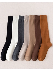Detailed flat lay of 7-color assorted knee-high cotton socks in neutral earthy tones