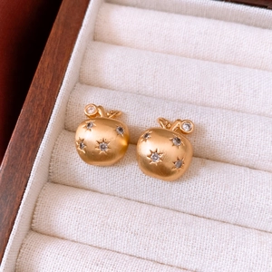 Detail of 18K gold-plated apple studs with brushed finish and white zircon stones