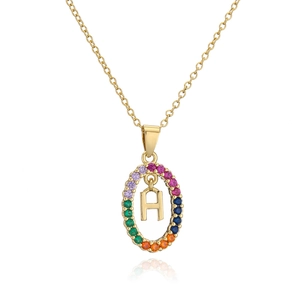 Macro detail of gold-plated oval necklace with multicolor zircon stones and letter H