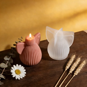 Pink heart wing angel candle and DIY striped ball resin silicone mold on wood surface
