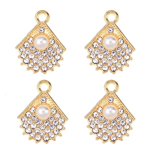 Detail of four golden fan-shaped pendants featuring pearls and clear zircons in 2x2 grid