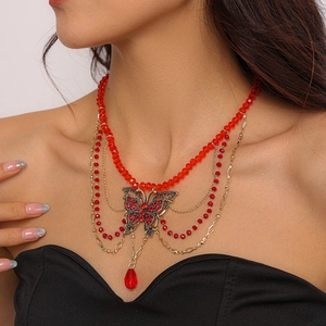 Macro view of vintage red beaded multi-layer necklace with rhinestone butterfly pendant