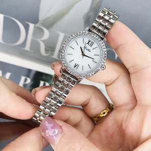Detailed close-up of a silver quartz watch with diamond bezel and Roman numeral dial
