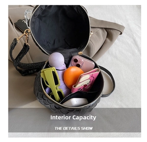 Detail view of the black owl shaped crossbody bag showing interior storage capacity