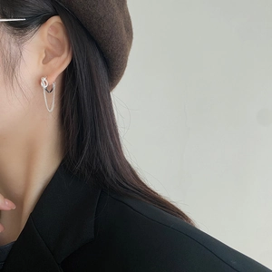 Close-up of 925 sterling silver twist stud earrings with double chain drop on model