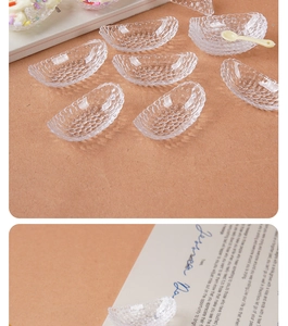 Close-up of a mini transparent crescent bowl with bubble texture and cream-colored spoon