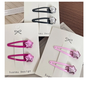 Detailed set of colorful star hair clips in black, rose red, and soft pink on display