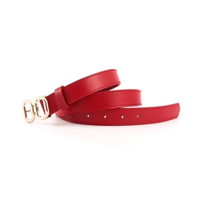 Detail of red leather belt featuring elegant gold double ring buckle and stitching