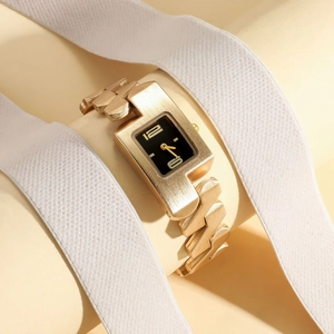Macro view of rectangle gold watch with thick chain strap on jewelry stand display