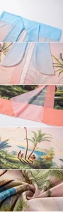 Close-up detail of tropical palm tree print on lightweight blue and pink cover-up fabric