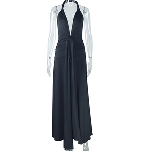 Detail of elegant black halter neck maxi dress featuring deep V-neck and draped waist design