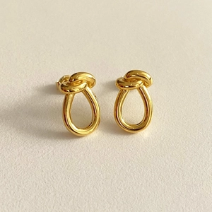 Minimalist 925 sterling silver knot earrings in a polished golden finish for women