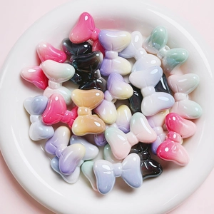Macro shot of colorful UV gradient resin bow beads for DIY jewelry and phone chain making