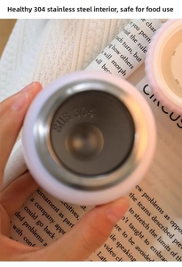 Detailed close-up of pink thermal cup featuring food-grade SUS 304 stainless steel interior
