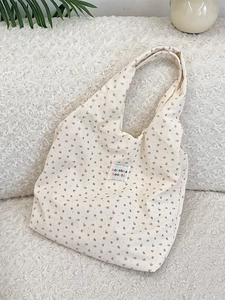 Minimalist corduroy floral tote bag with sozakka beaute label on soft fur background