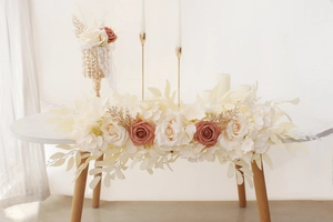 Close-up of artificial rose floral runner in white and caramel colors for wedding tables