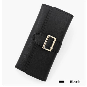 Close-up of black pebble grain faux leather wallet with gold metal buckle closure