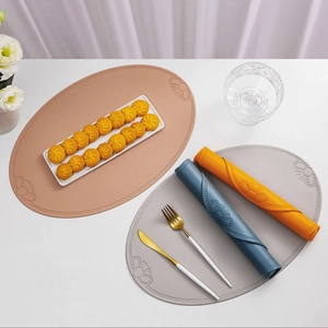 Macro detail of oval faux leather placemats with vintage embossed floral pattern textures