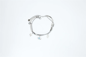Detail of layered stainless steel bracelet with blue evil eye and star charms