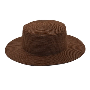 Detailed view of the dark brown straw boater hat featuring fine spiral weave texture