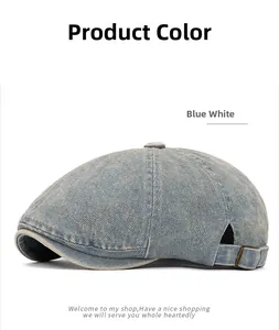 Close-up of light blue washed denim beret featuring an adjustable bronze metal buckle