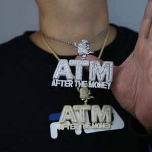 Detailed macro of silver iced-out ATM pendant with zircon stones on a twist chain