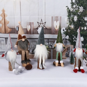 Handcrafted Christmas gnomes set with knitted hats and wooden stands for festive home decor