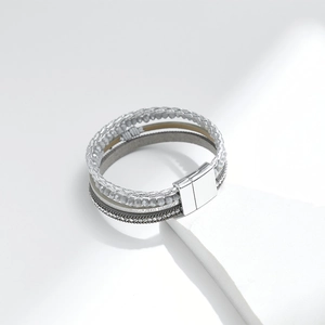 Close-up of bohemian multi-layer bracelet with silver beads and magnetic metal clasp