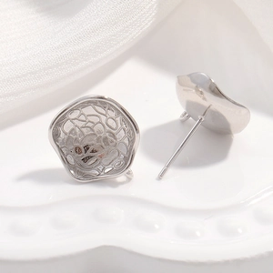 Detail view of S925 sterling silver fan-shaped earring components with hollow patterns