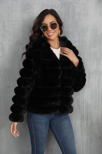 Close-up of black faux fur jacket showing horizontal stripe texture and soft plush material