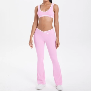 Detail of high-waist V-shaped waistband on pink yoga flare pants with white contrast piping