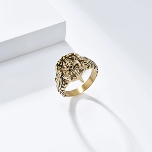 Detailed relief of skull and sword on a gold-finish stainless steel vintage ring