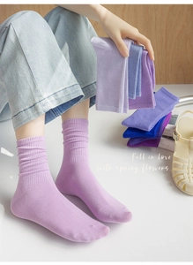 Detailed knit texture of purple crew socks made of comfortable cotton blend fabric