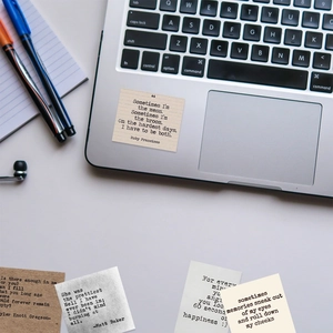 Close-up of vintage inspirational quote stickers on a laptop with stationery background