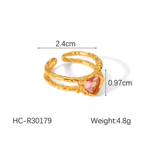 Close-up of gold hammered adjustable ring with pink heart-shaped stone detail